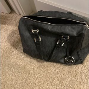 All black medium to large Michael kors hand bag. Lightly used. Silver accents.